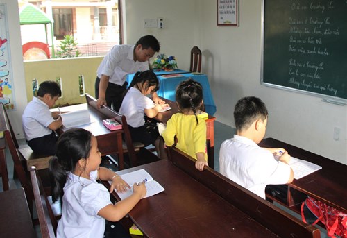 Thầy Lê Xuân Quyết và các em học sinh tại lớp học trên đảo Song Tử Tây.